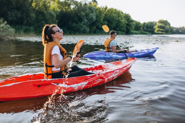 Couple together kayaking on the river
